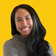 Headshot of Abby on a Dandelion yellow background.
