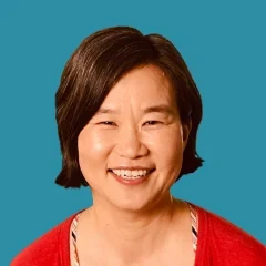 Headshot of Katie Hong on an pond-colored background.