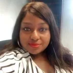 Headshot of Chantias Ford, looking at the camera with a slight smile, with long dark hair, hoop earrings and red lipstick, wearing a white-and-black striped top against an indoor background.