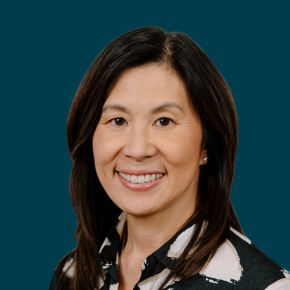Headshot of Jill Nishi over a blueberry colored background