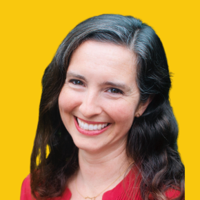 Headshot of Katy Love, smiling, with long wavy dark hair and gray streaks, wearing a red blouse and delicate necklace against a dandelion-yellow background.