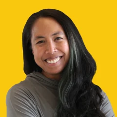 Headshot of Abby on a Dandelion yellow background.