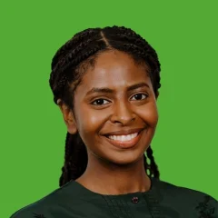 Headshot of Mares Asfaha on a grass-colored background.