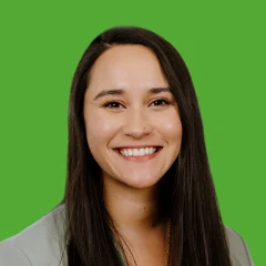 Headshot of Mika Day over a grass colored background