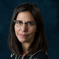 Headshot of Laurie Wolf over a dark blue background