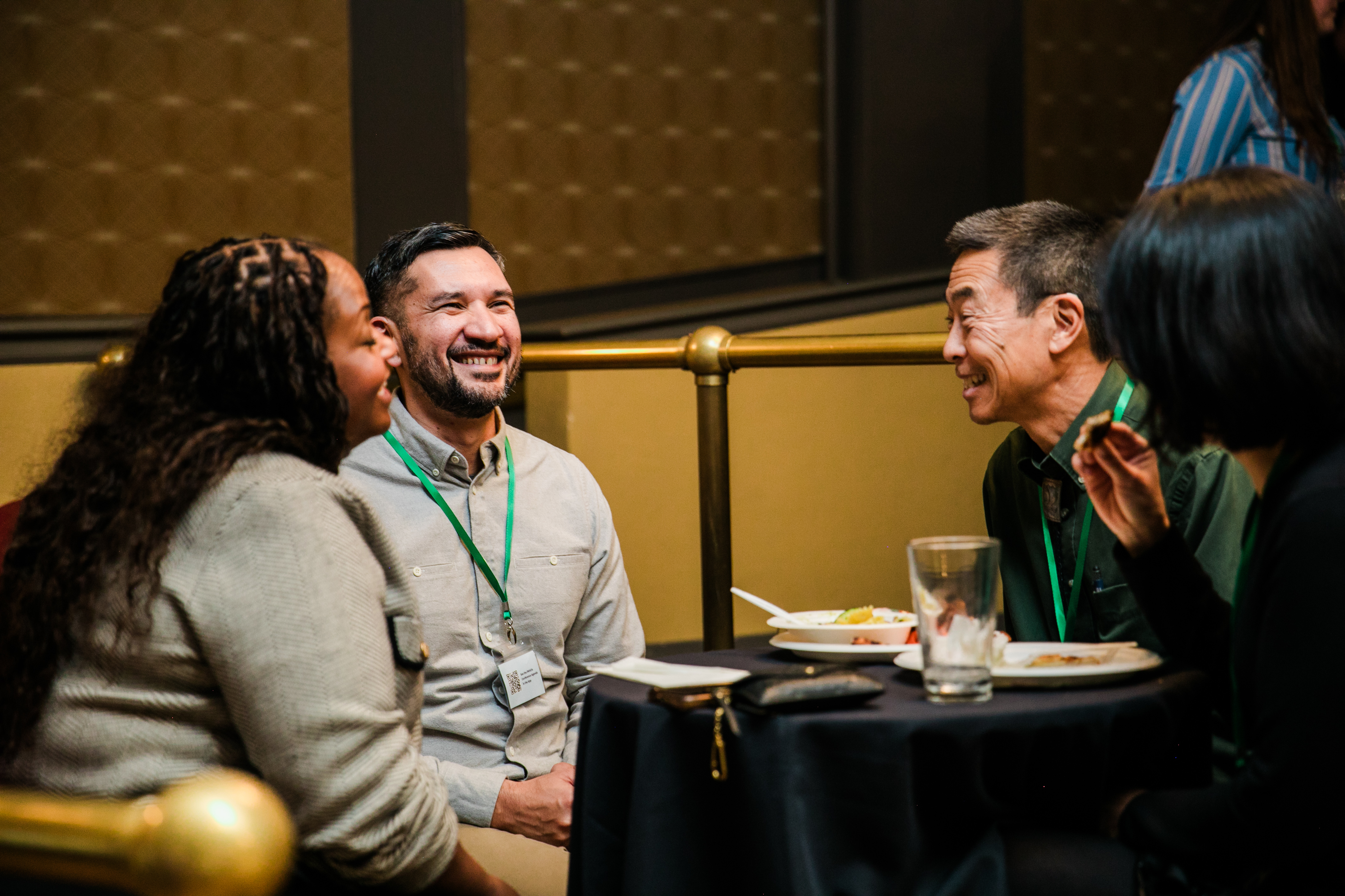 PNW24 conference attendees mingling and laughing at the welcome reception.