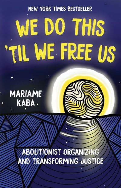 Book cover for “We Do This ’Til We Free Us: Abolitionist Organizing and Transforming Justice” by Mariame Kaba, featuring bold yellow text against a dark night sky above an illustrated moonlit pathway and blue patterned landscape.