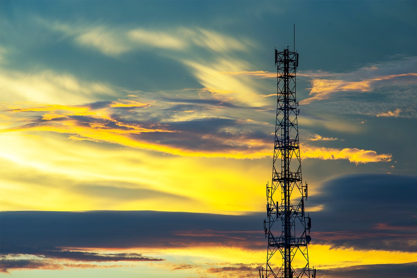 Telecommunication tower with a sunset sky background