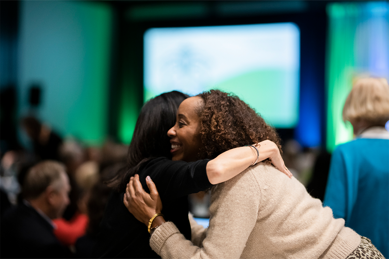 Two women at a Philanthropy Northwest conference hugging