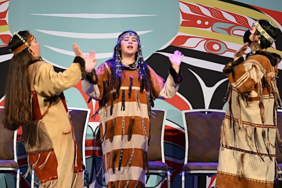 Photo of Alaskan Native youth during the First Alaskans Institute Elders and Youth Conference performing on stage