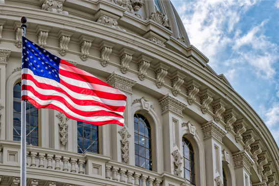 Capitol Dome with the American Flag infront of it