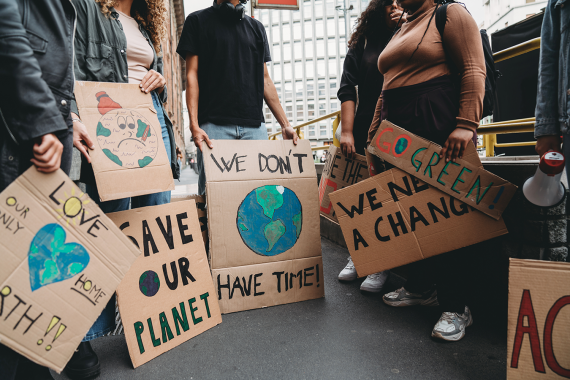 An image of protestors holding signs related to climate change.