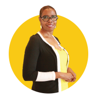 Robin's headshot. Robin is wearing a black cardigan and yellow blouse. 