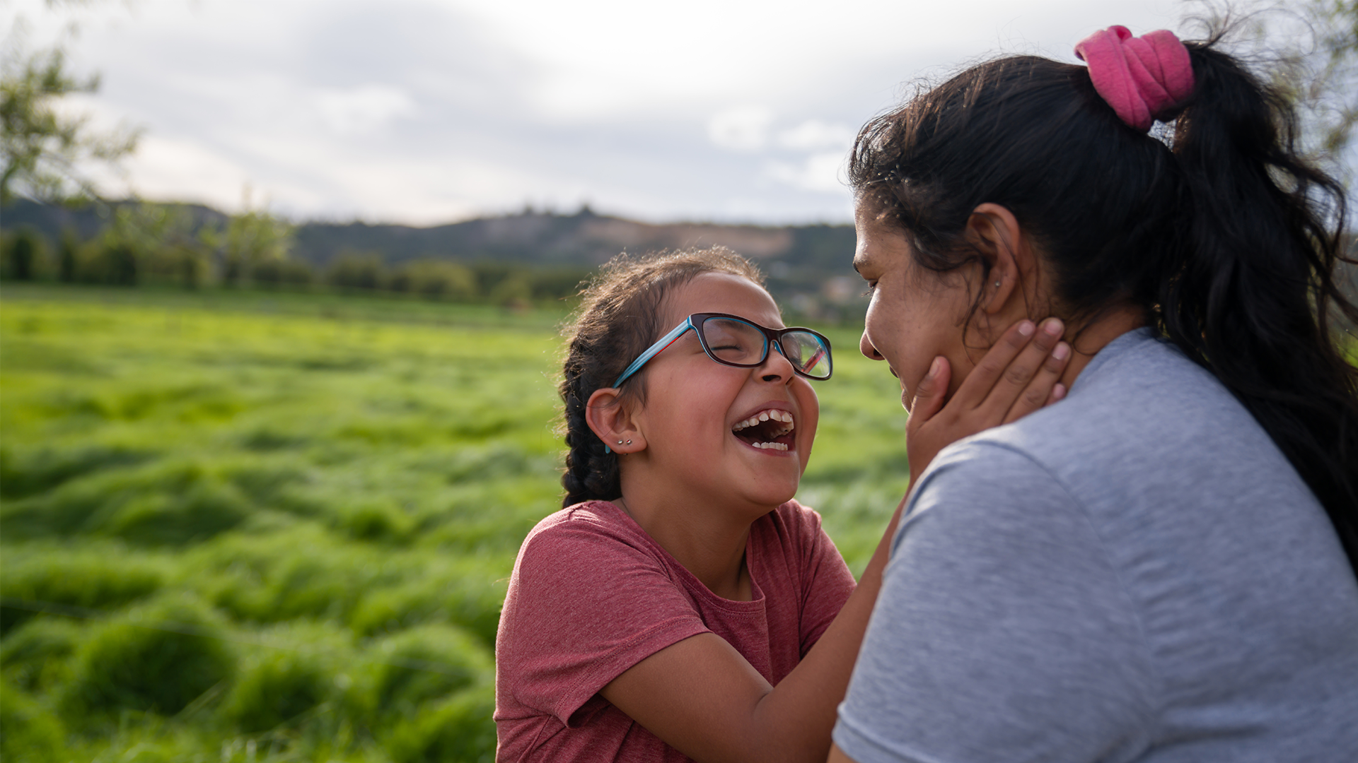 Portrait of a loving girl having fun with her mother at a farm and laughing.