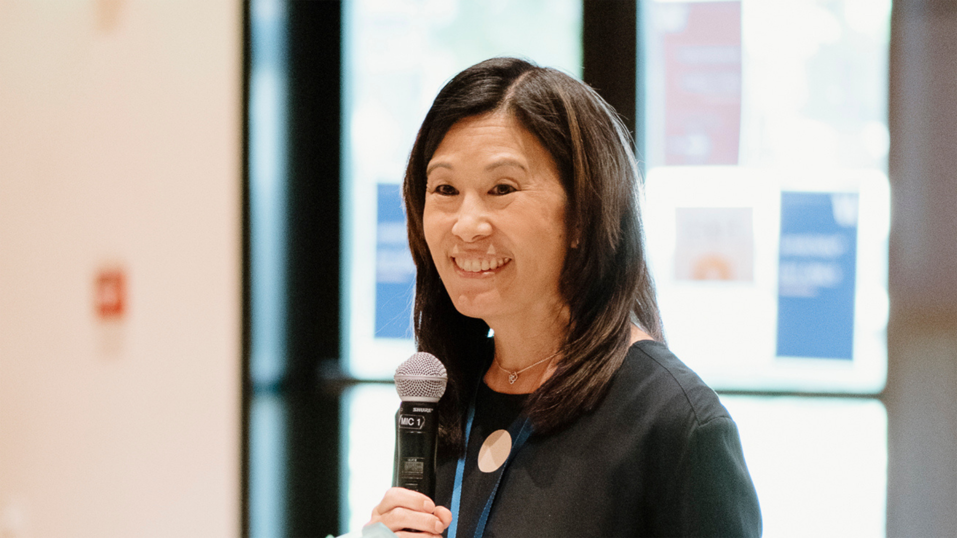 Photo of Philanthropy Northwest's CEO Jill Nishi with a microphone