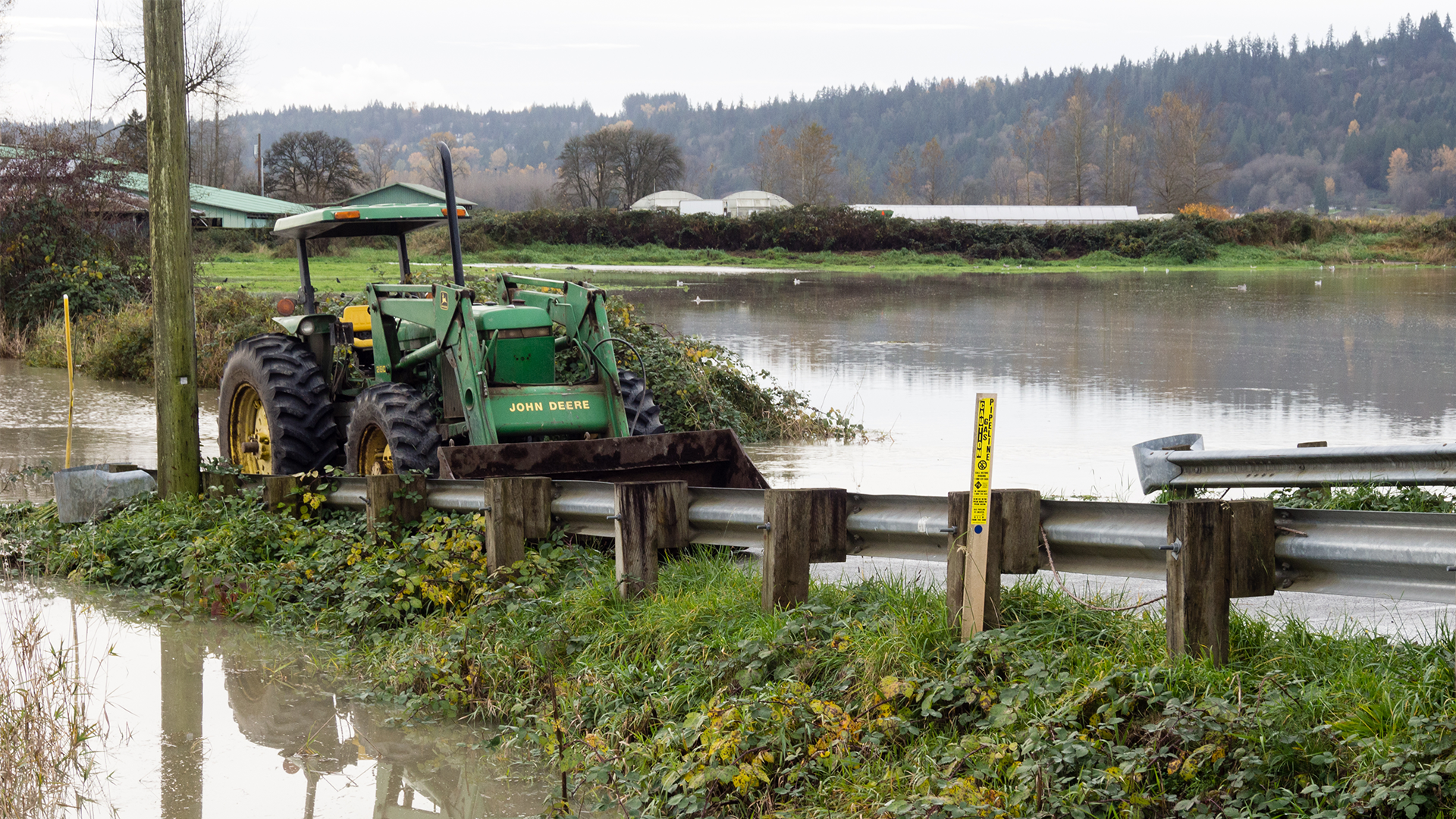 Farming tractor on a flooded road in Washington state.