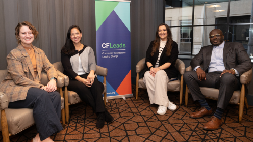 Photo of four folks from the CF Leads Regional Economic Mobility Convening sitting in chairs in front of a CFLeads banner