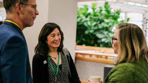 Photo of Jill Nishi, Philanthropy Northwest CEO, at PNW24 talking with two attendees.