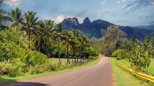 Road to Anahola Beach, with mountain range in the background on North Shore of Kaua'i, HI
