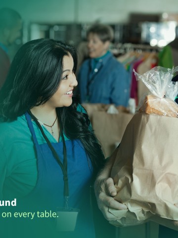 WA Food Fund Banner with image of woman at food bank giving a bag of groceries to an elder man