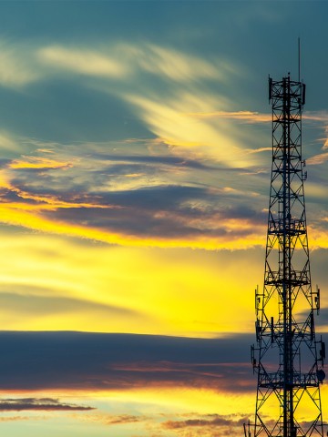 Telecommunication tower with a sunset sky background
