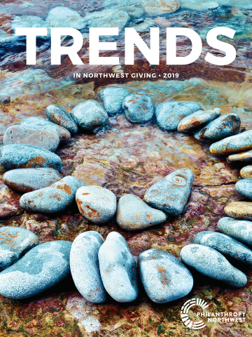 Image of Trends in NW Giving report cover with a spiral of rocks in water