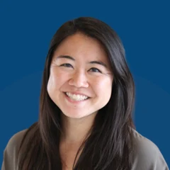 Headshot of Aya Tsuruta over a blueberry background