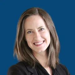 Headshot of Emily Daman over a blueberry background