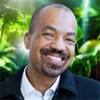 Picture of Rashad Morris, Strategy Consultant, in a white shirt and black jacket in front of a green background
