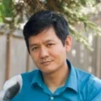 Headshot of Vu Le, author and writer in a blue shirt.  